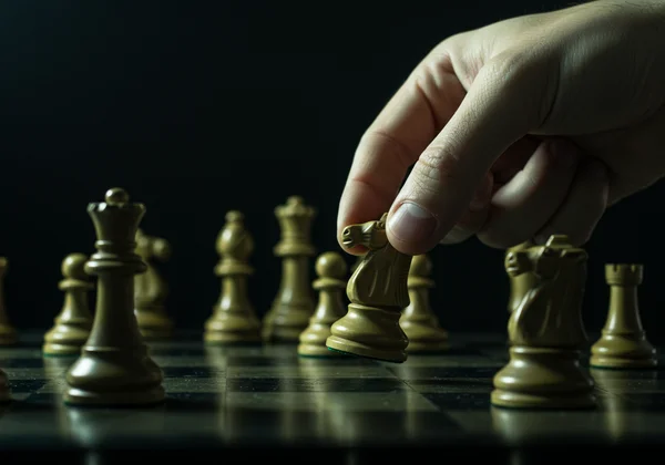 Person playing chess, representing strategic thinking.